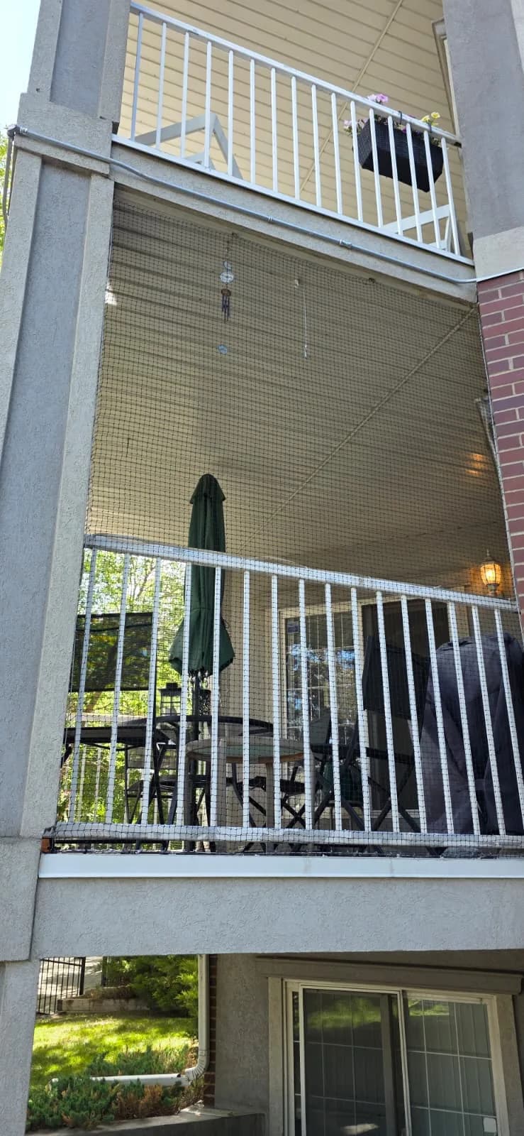 Bird netting between apartment balcony levels blocking pigeon access