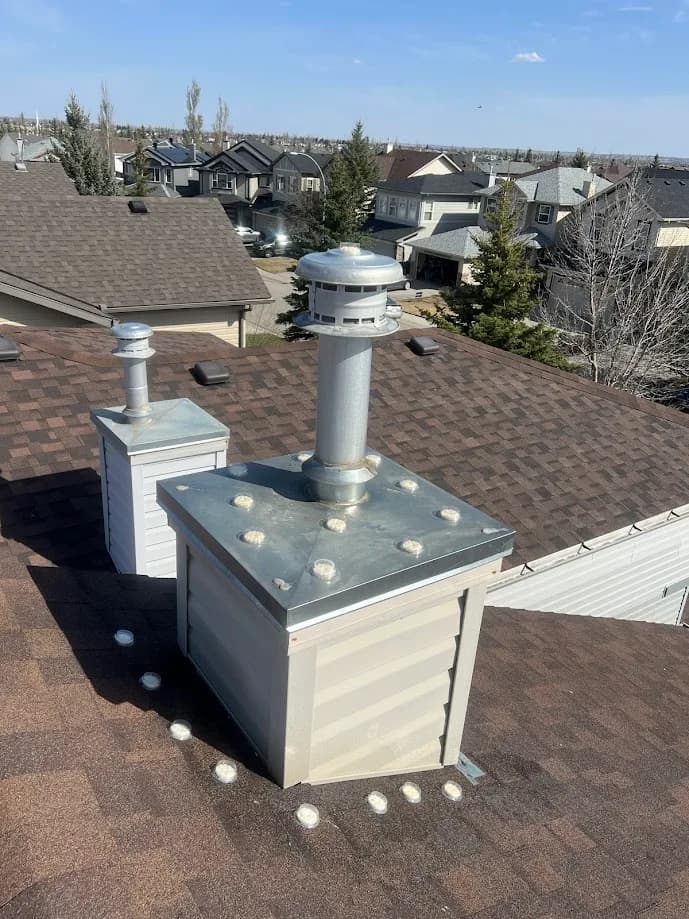 A rooftop vent exclusion install with the surrounding neighbourhood behind