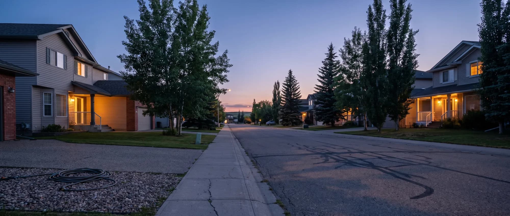A quiet residential street in suburban Calgary at dusk