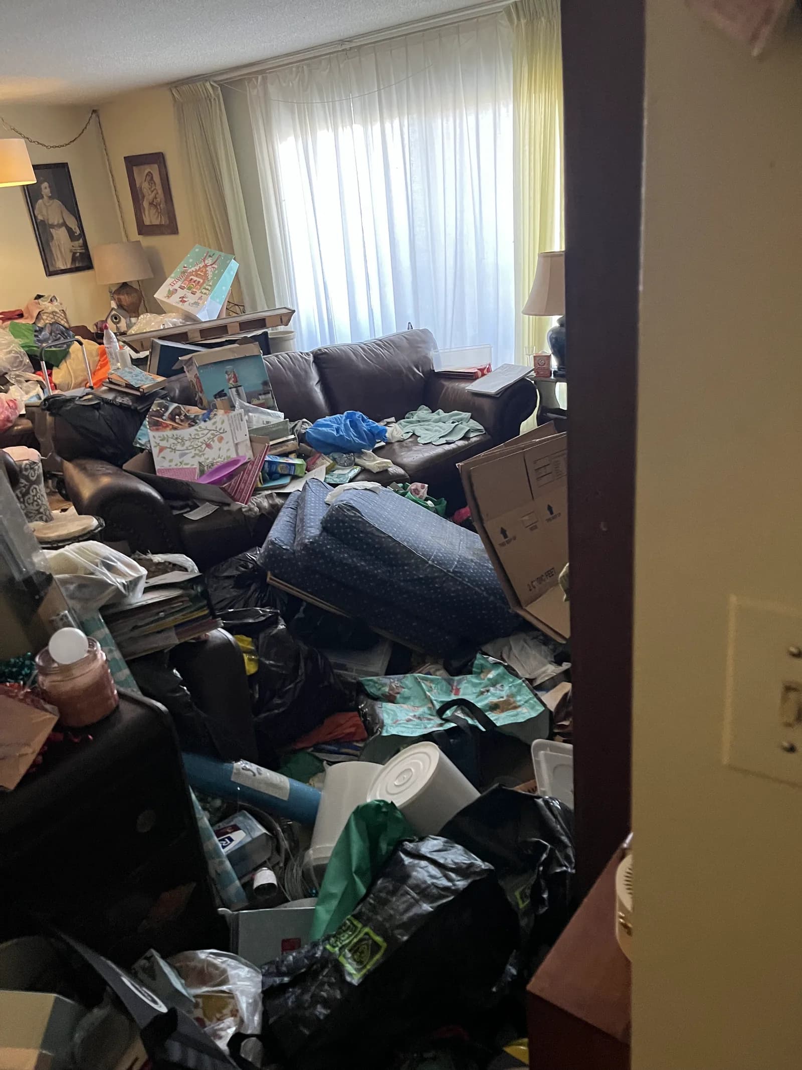 A hoarding-condition living room before cleanup