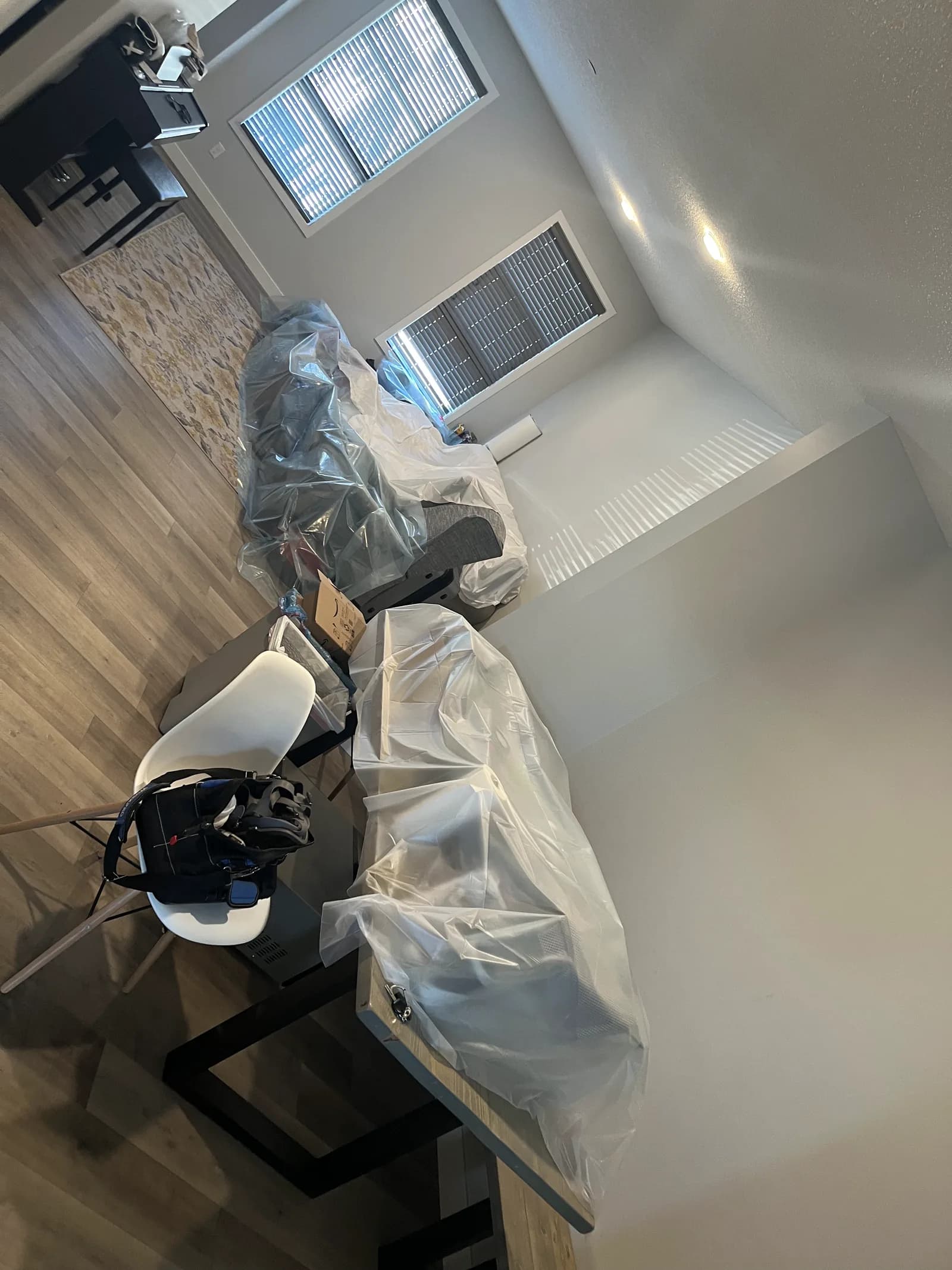 Furniture wrapped in plastic sheeting during treatment preparation