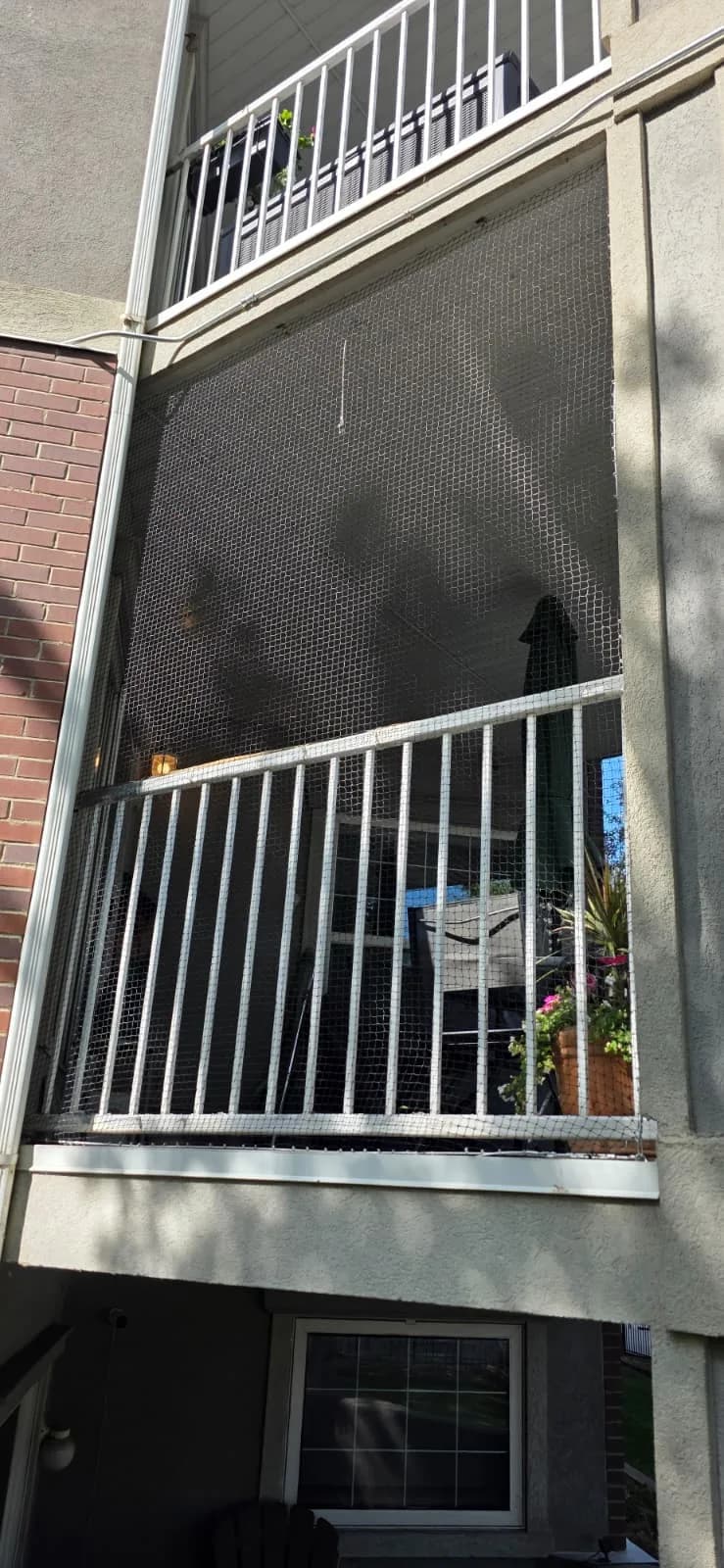 Exclusion netting fitted across two floors of balconies on an apartment building